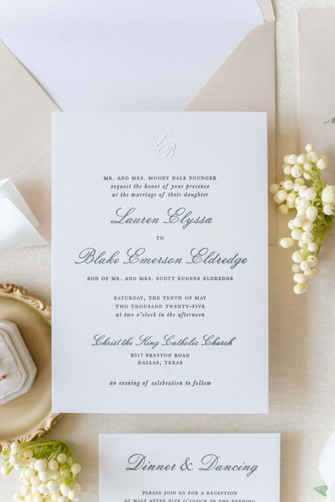 Elegant letterpress wedding invitation card with blind pressed monogram