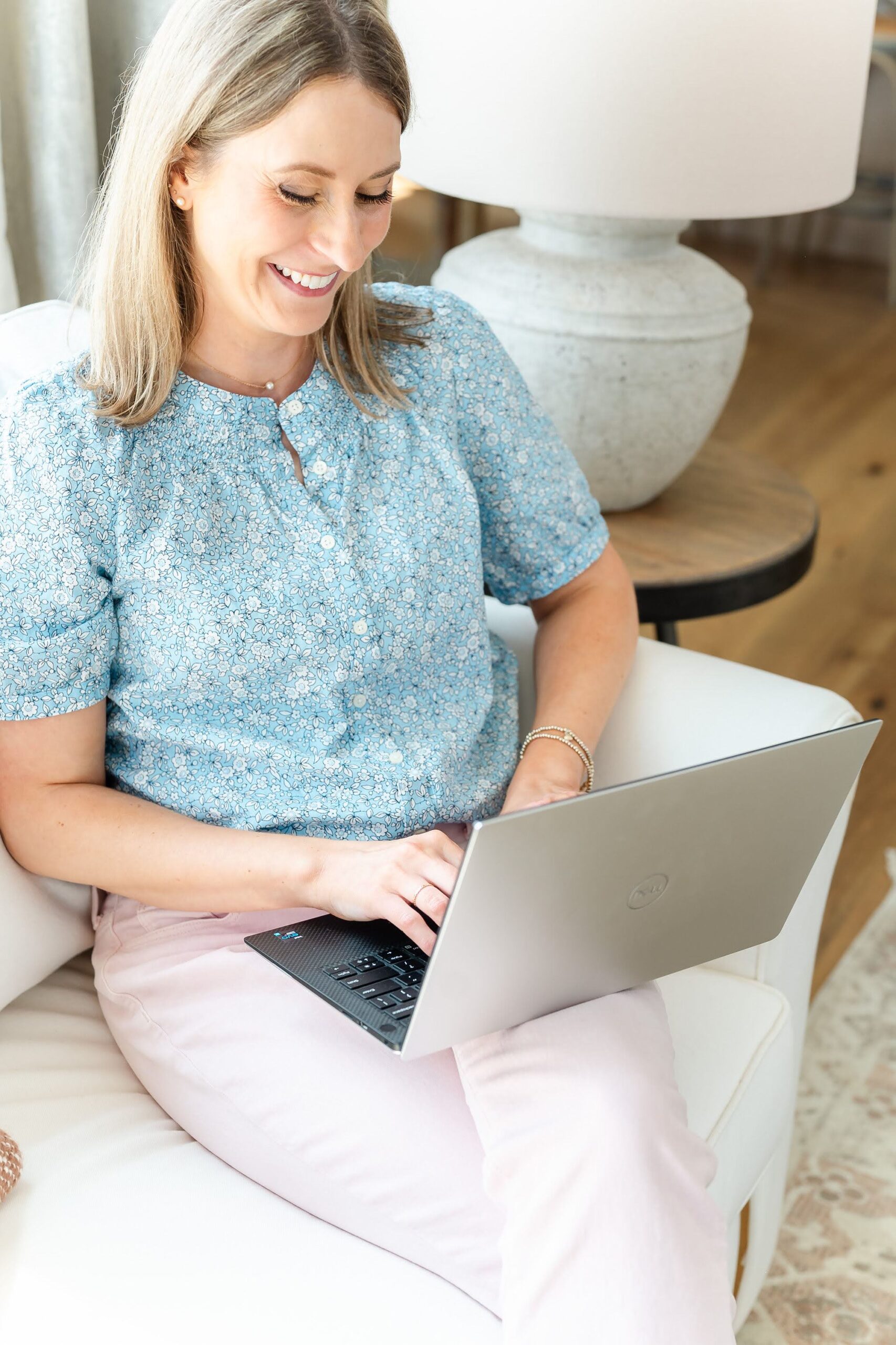 Engaged woman typing on a computer and making her wedding guest list