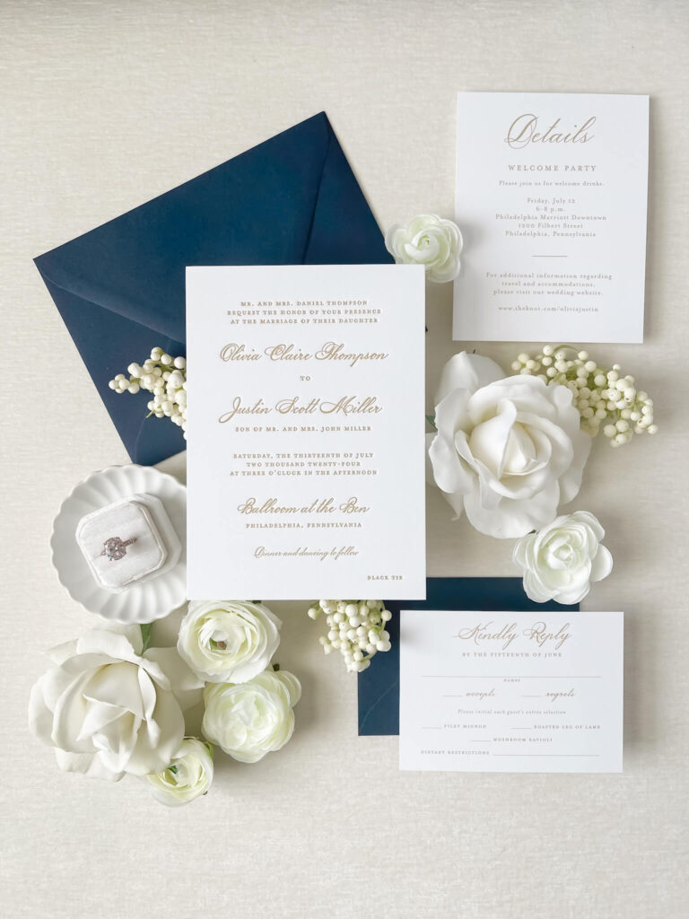 Custom timeless gold letterpress wedding invitation suite that includes navy blue envelope, along with corresponding RSVP and Details card.