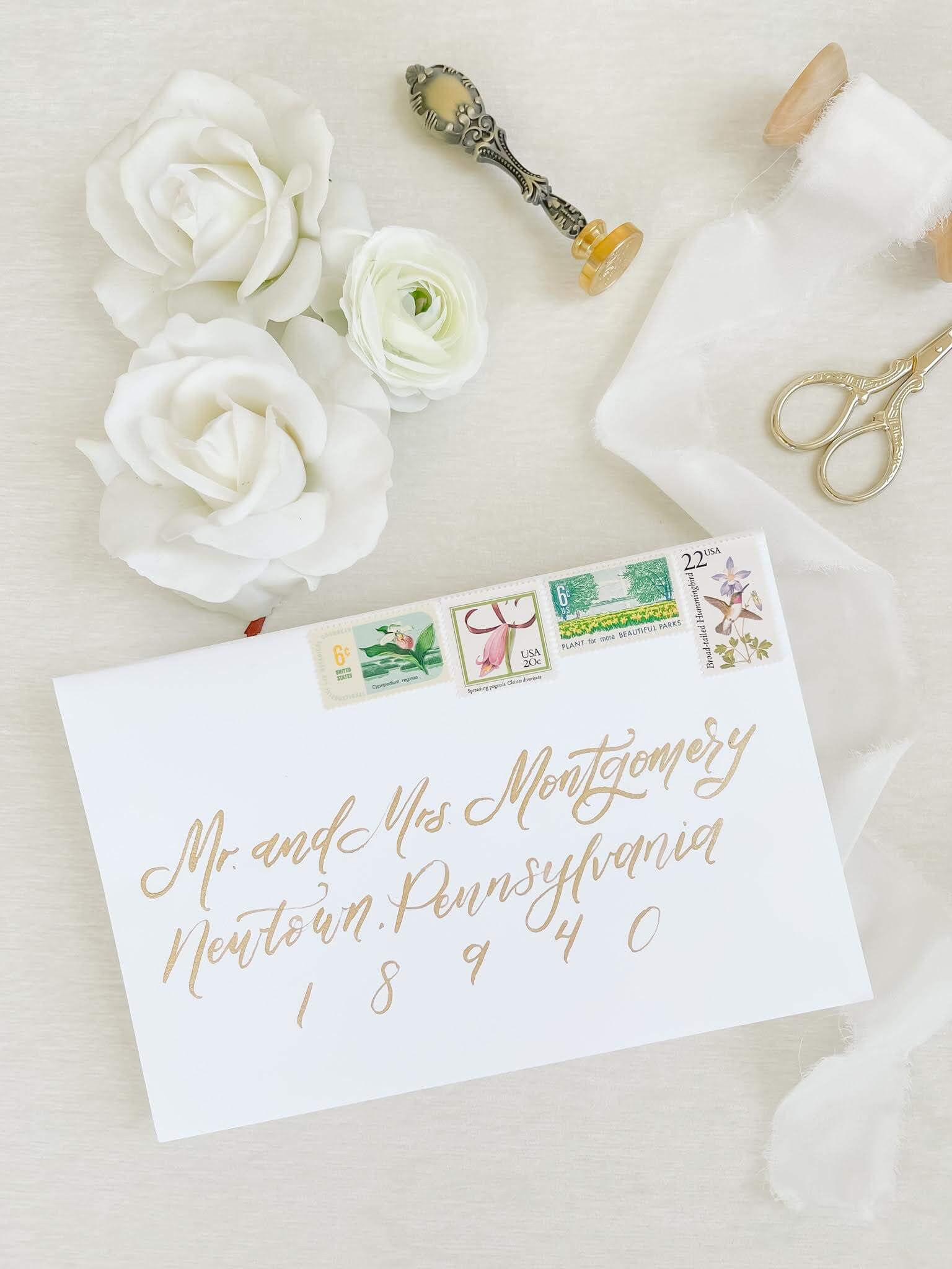 Wedding invitation envelope addressed with elegant gold calligraphy