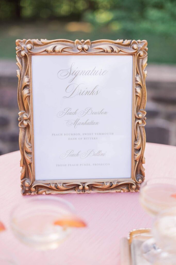 Signature drink sign featuring peach-themed cocktails