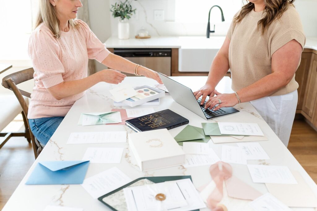 Wedding stationers working to design wedding invitations for couples