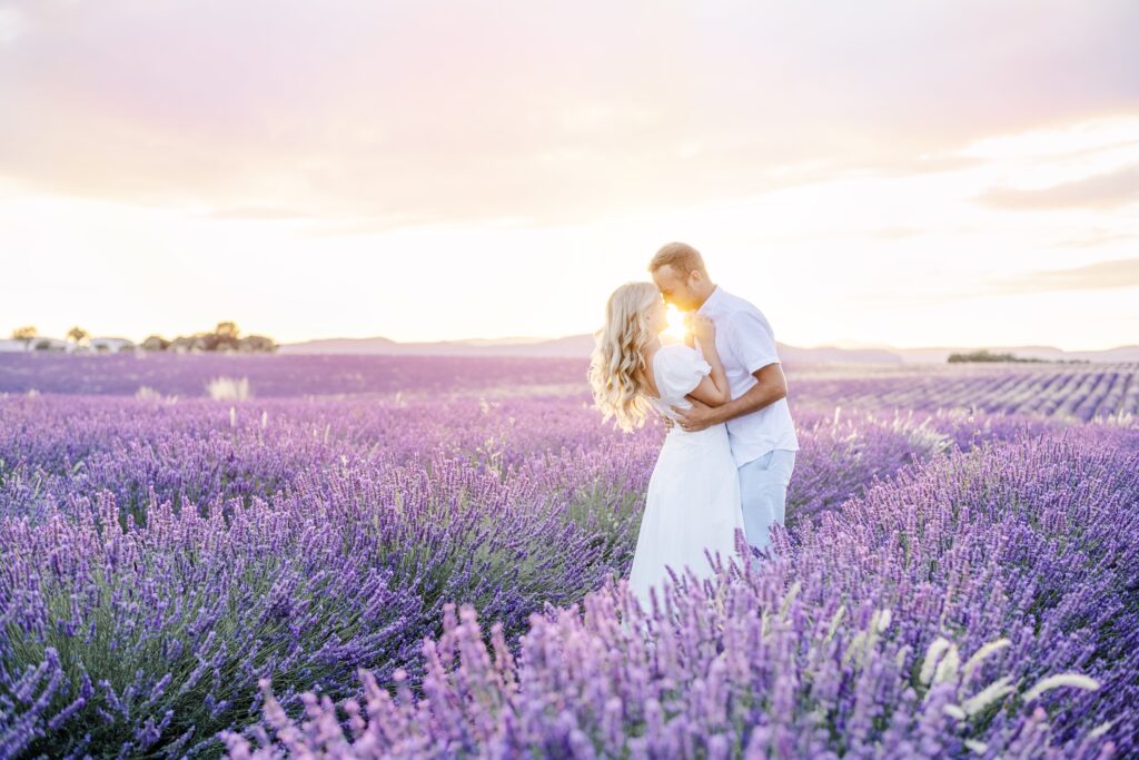 Engaged couple embracing in a lavender field