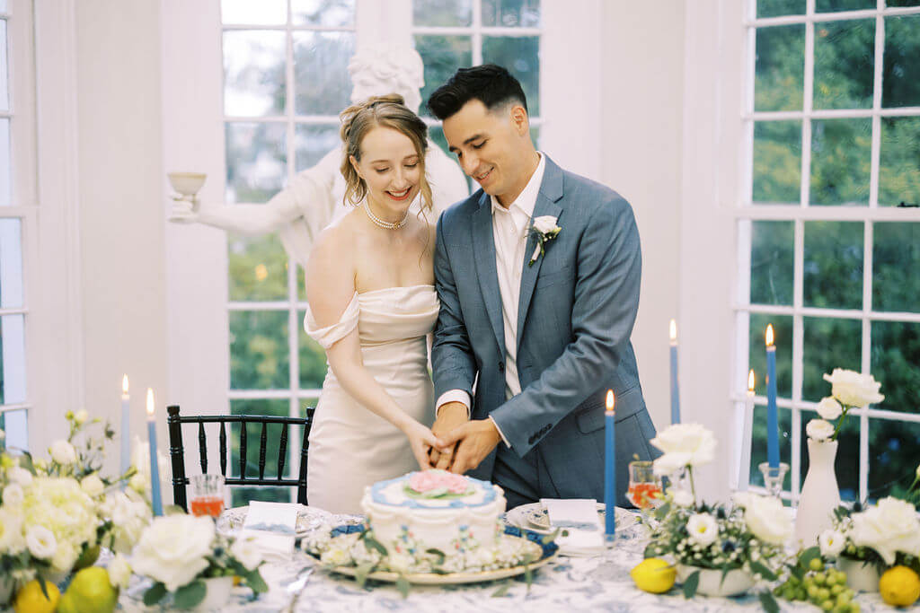 Married couple cutting cake