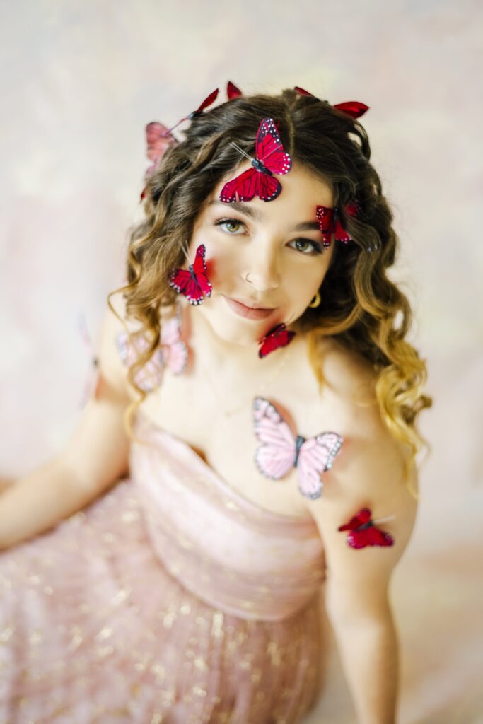 Romantic portrait of woman with butterflies on face