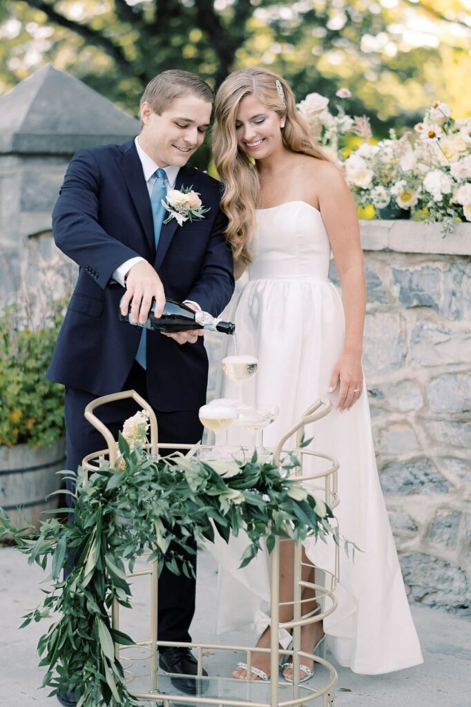 Bride and groom pour champagne