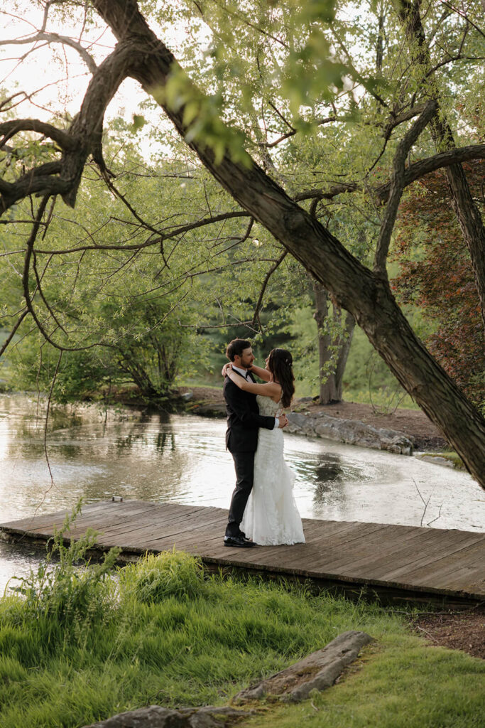 A bride and groom dance on a dock, one of the ceremony locations at The Farm at Eagles Ridge
