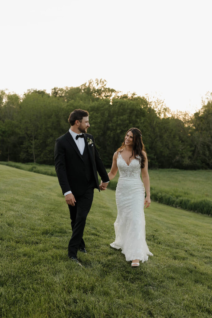 A bride and groom stroll the grounds of The Farm at Eagles Ridge, a Lancaster County wedding venue