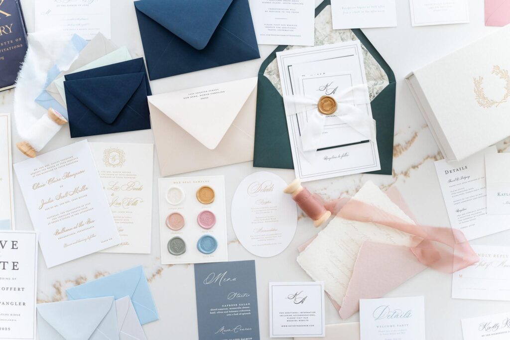 Luxury wedding invitation cards and embellishments lying on a countertop