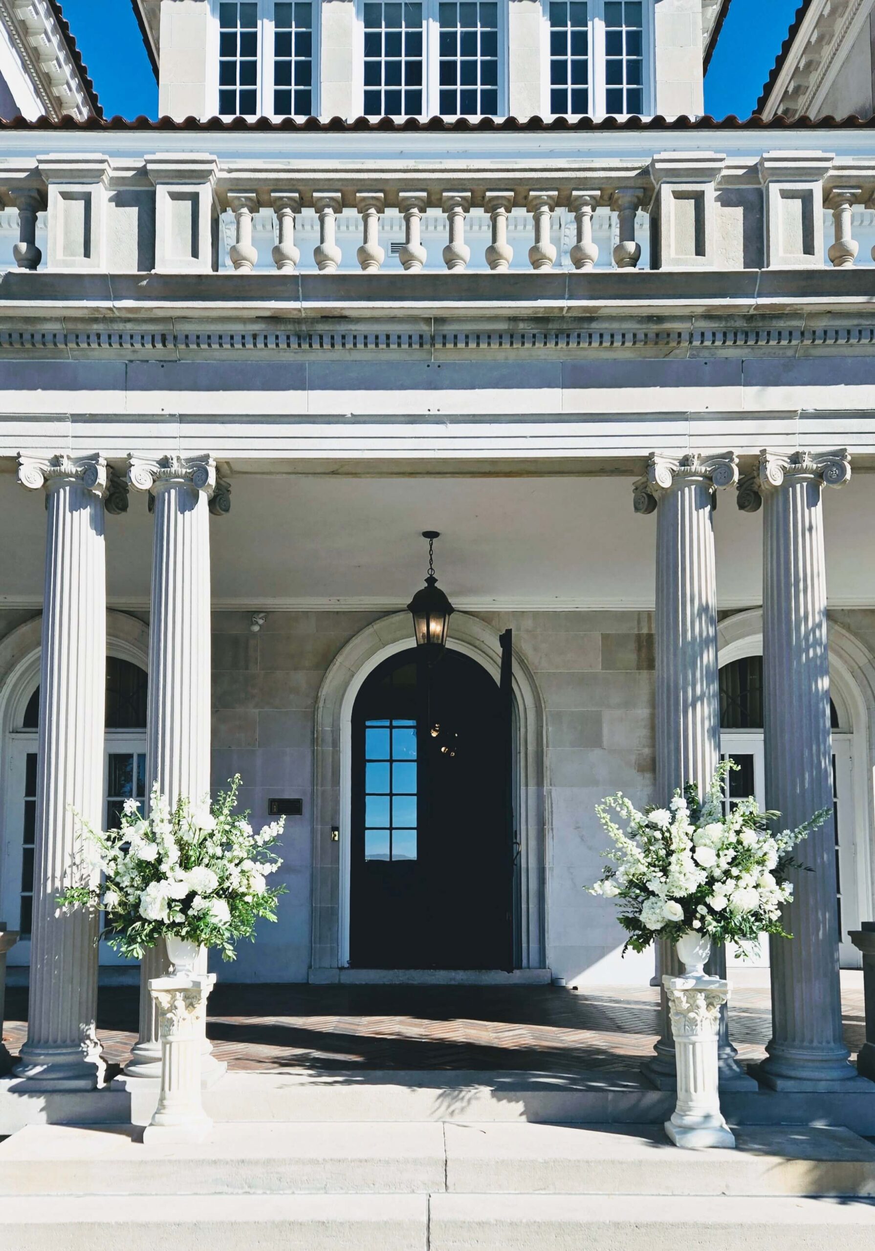 Classic white and green wedding floral urns
