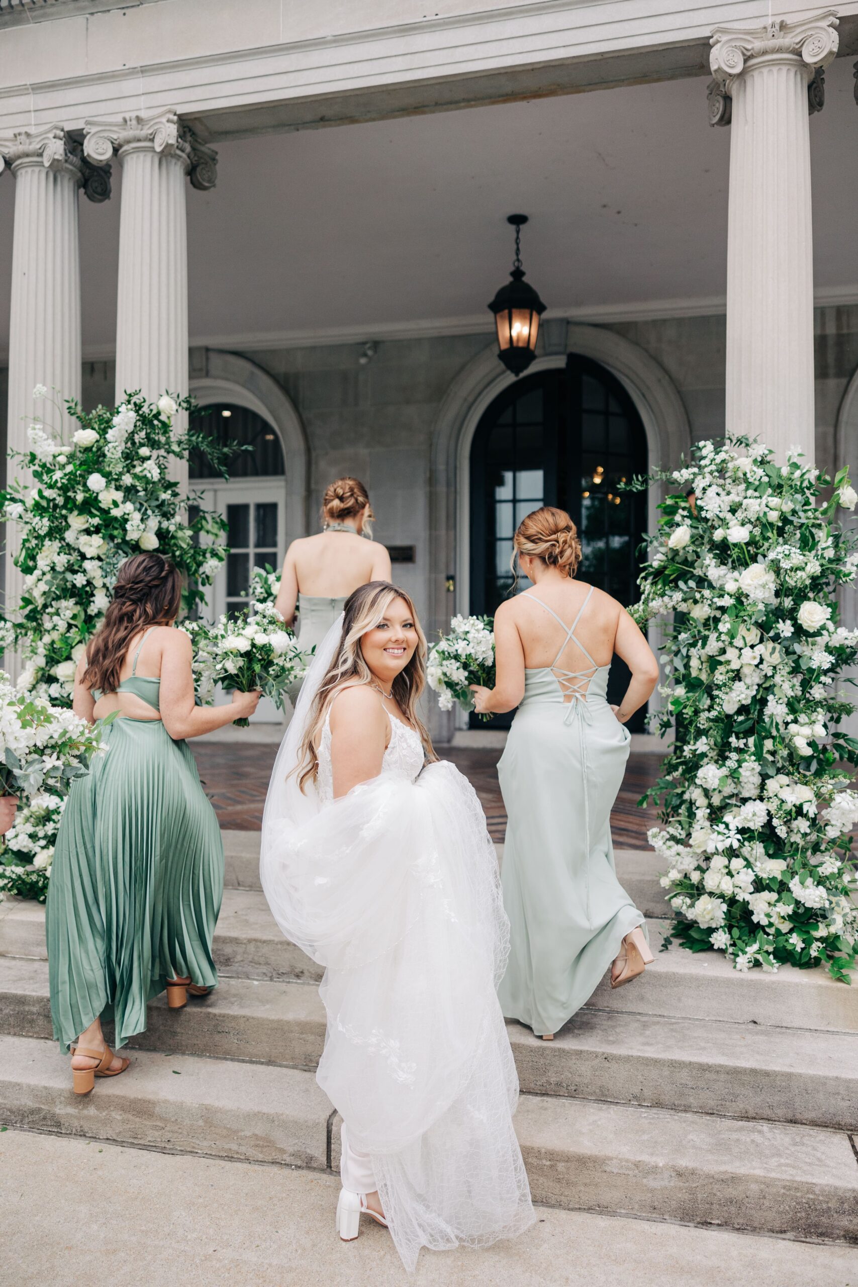 Classic white and green wedding floral 
arches