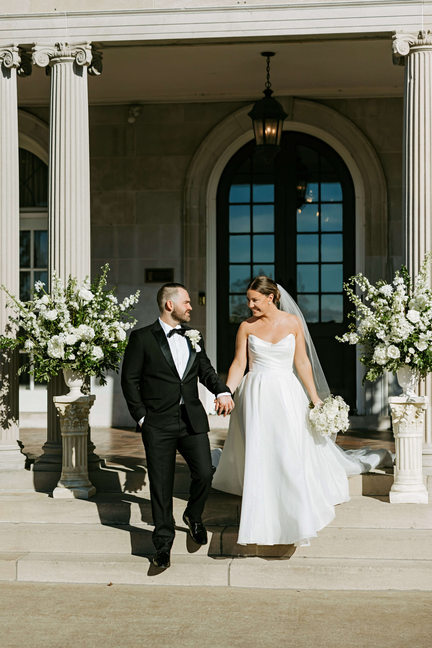 Couple surrounded by classic white and green wedding florals