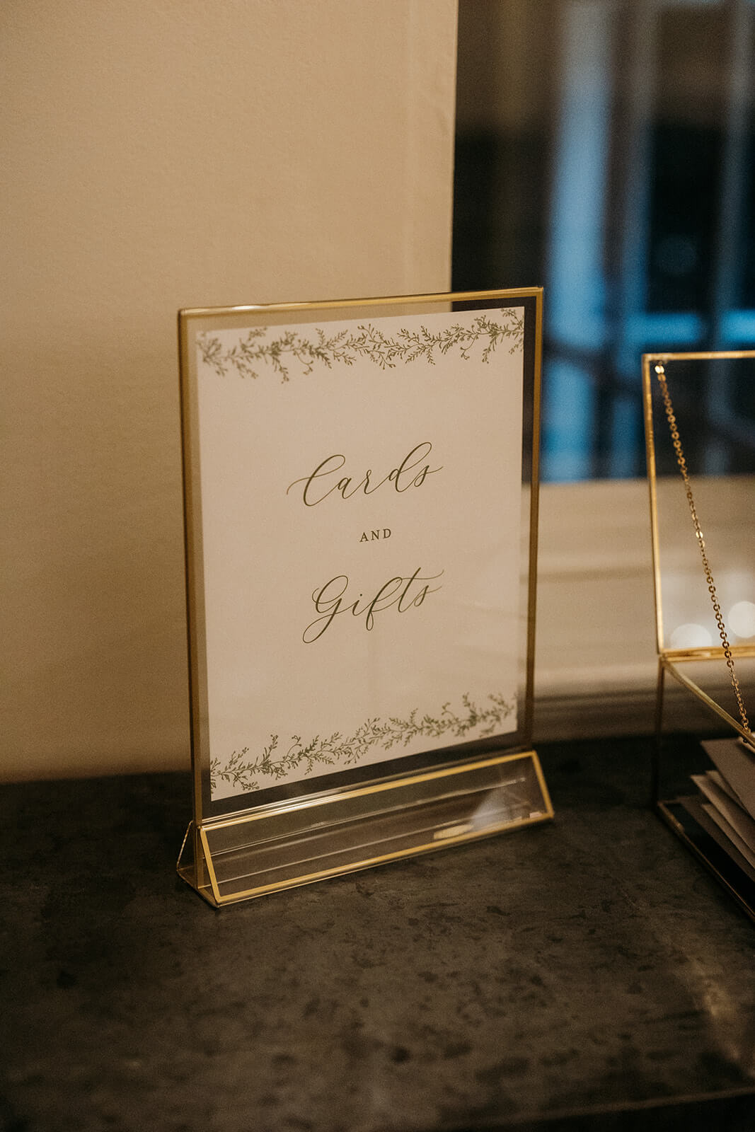 Elegant cards and gifts sign with greenery artwork in a gold frame