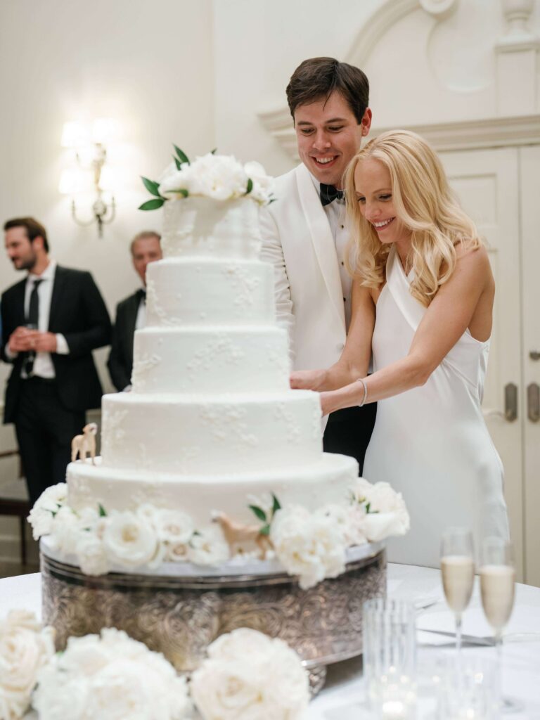 Bride and groom cutting their four-tier wedding cake