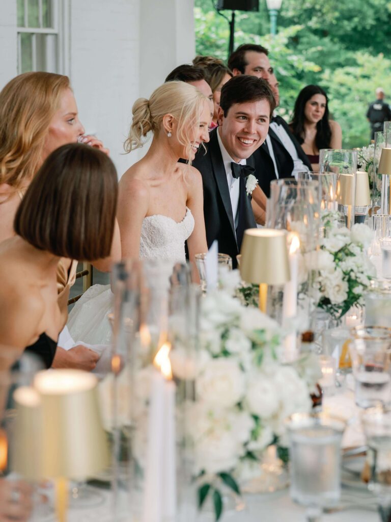Wedding party at head table listening to toasts