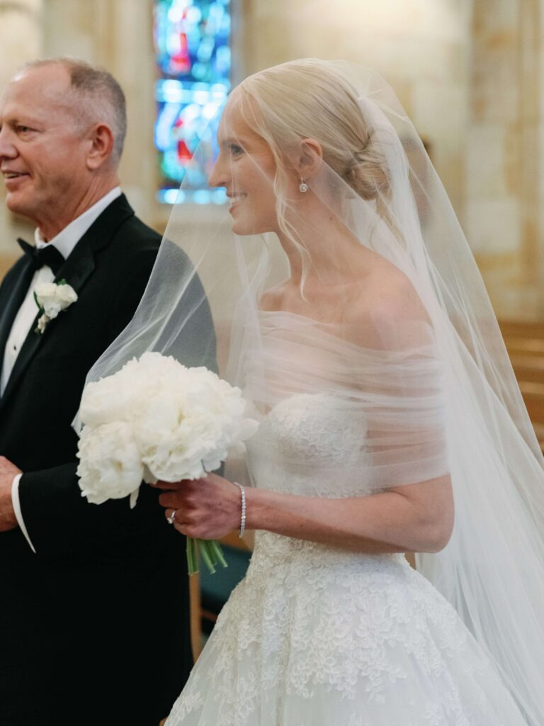 Father escorting bride down aisle