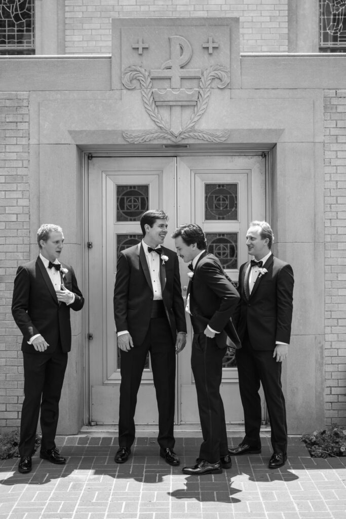 Groom with groomsmen candid portrait outside church