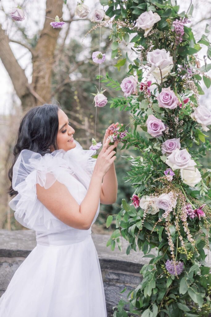 Bride with lilac wedding ceremony arch