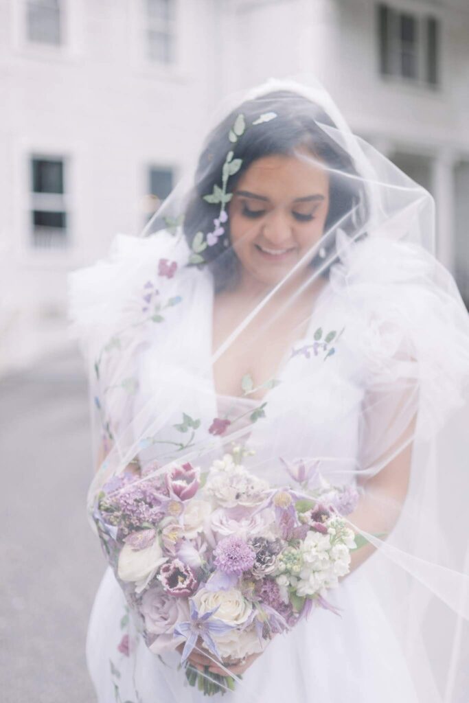 Bride wearing hand-painted purple floral veil