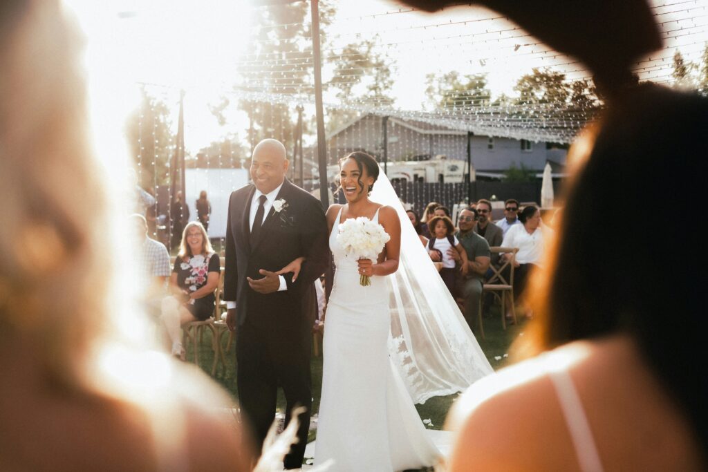 Father escorting bride down aisle during wedding ceremony