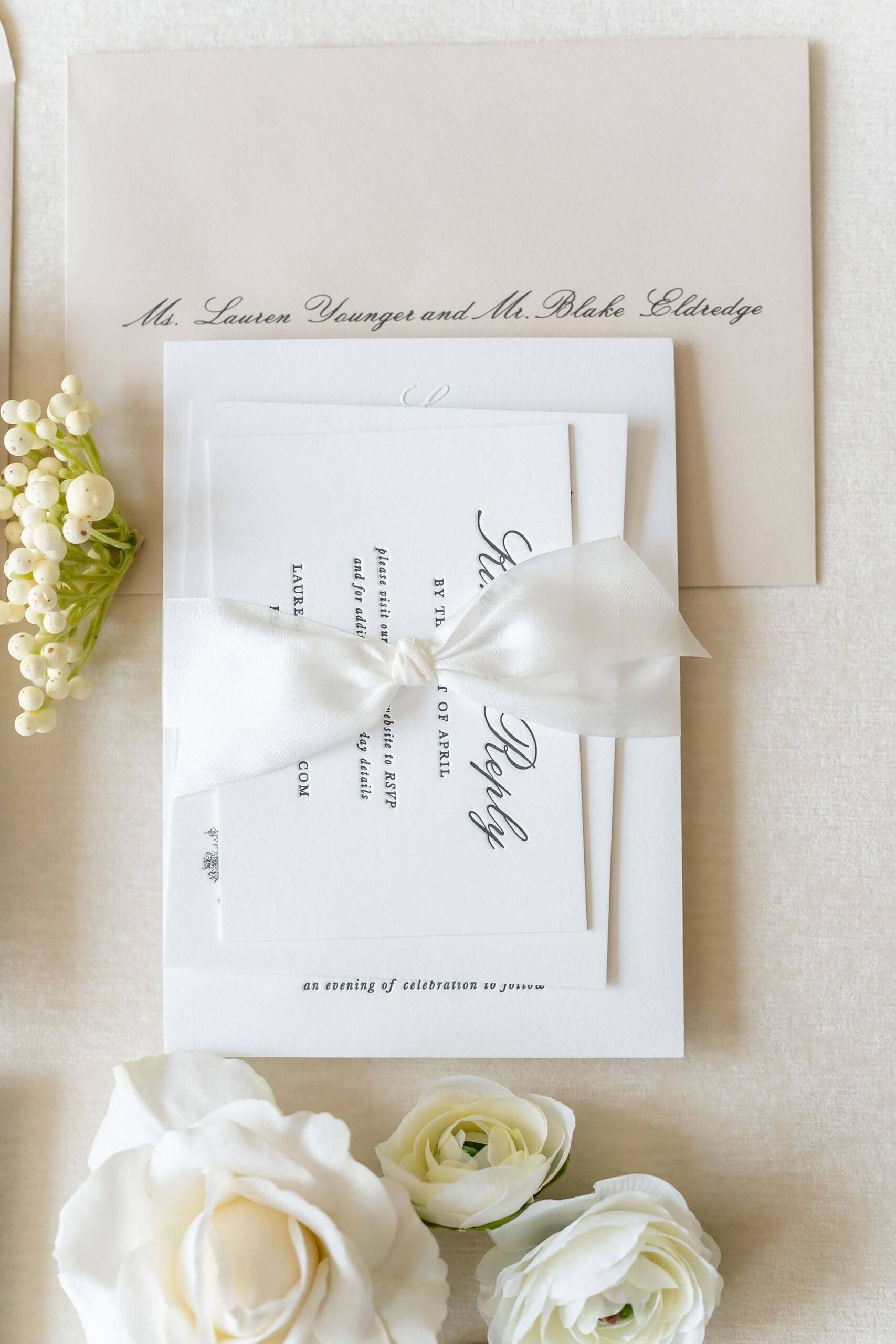 Wedding invitation suite tied with an elegant white silk ribbon