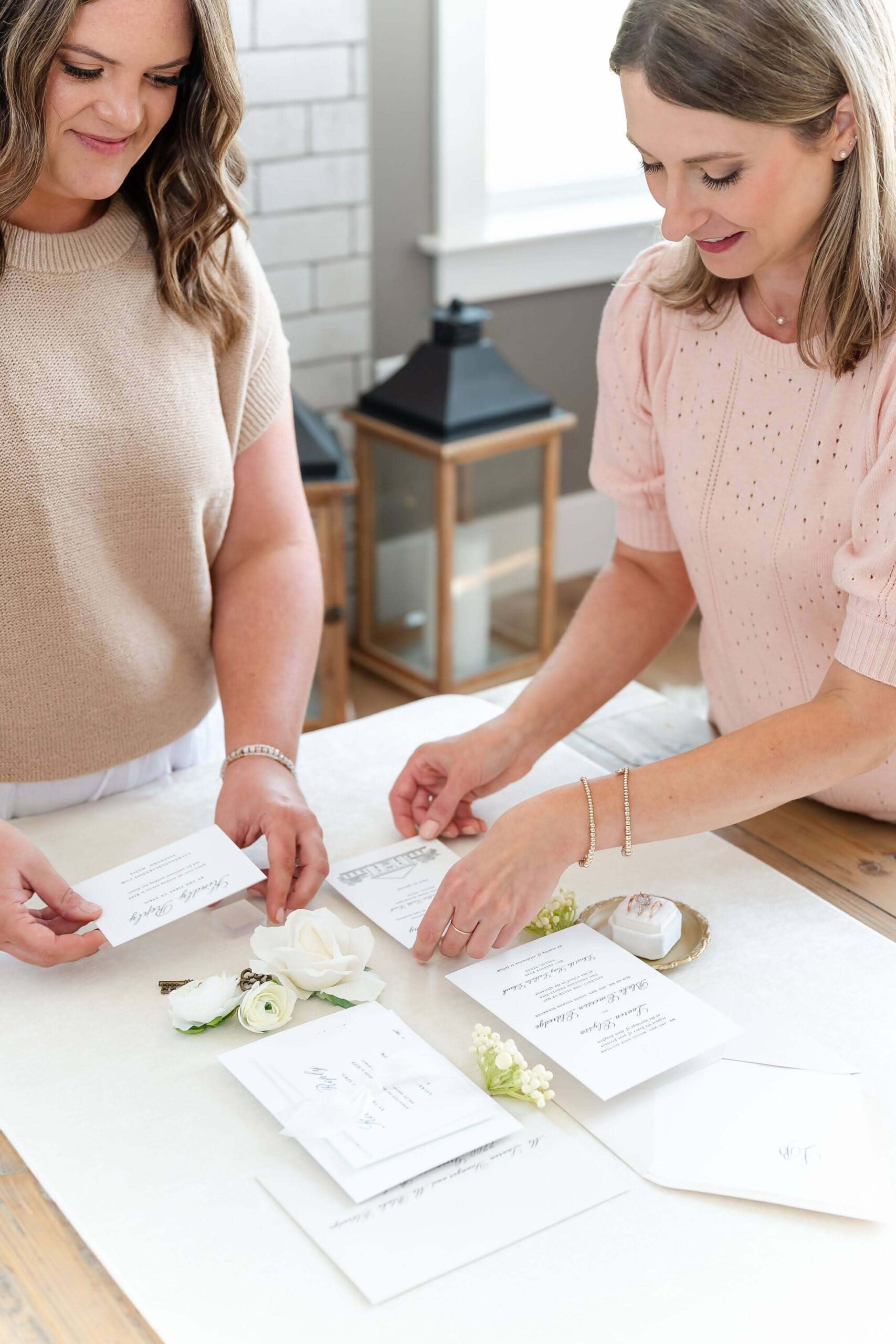 Wedding stationers Emily and Heather of Heather Paperie arranging a classic suite flat lay