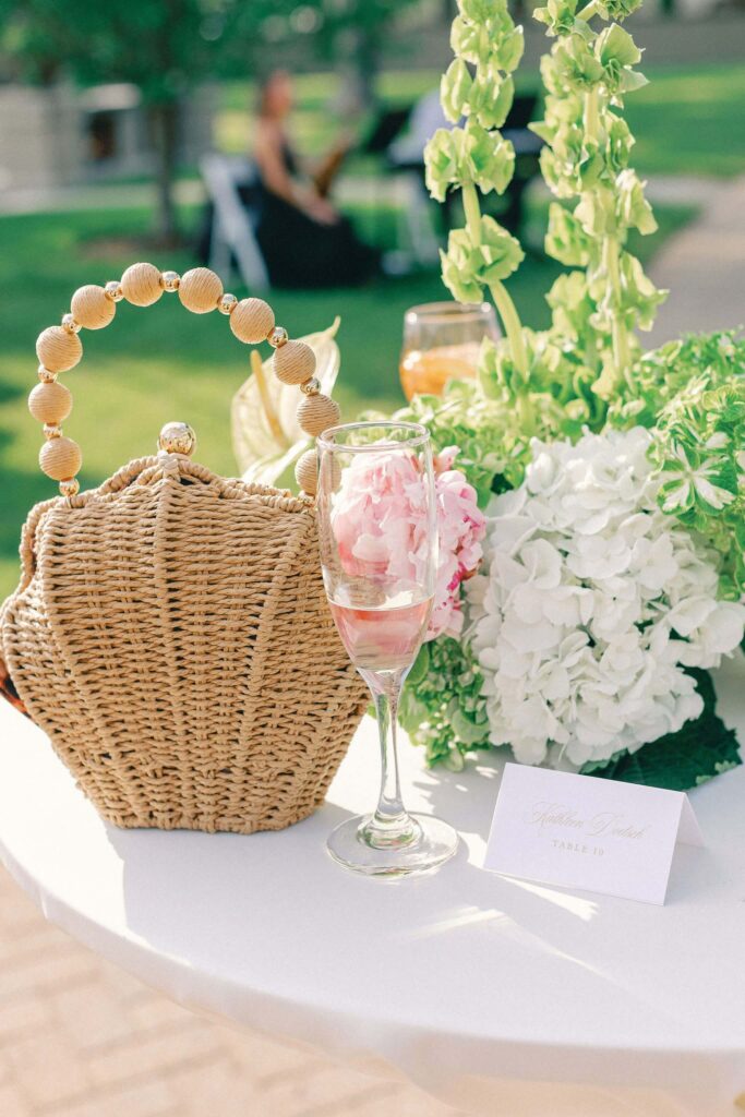 Spring wedding details on a table, including pink and green flowers