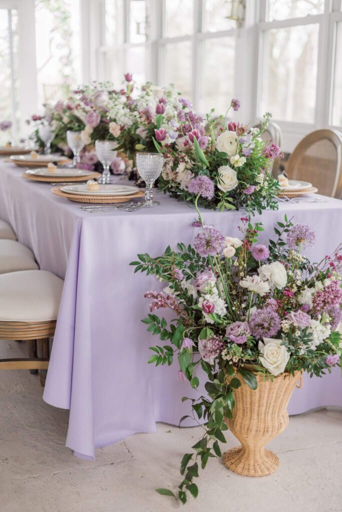 Wedding reception table with florals in shades of purple