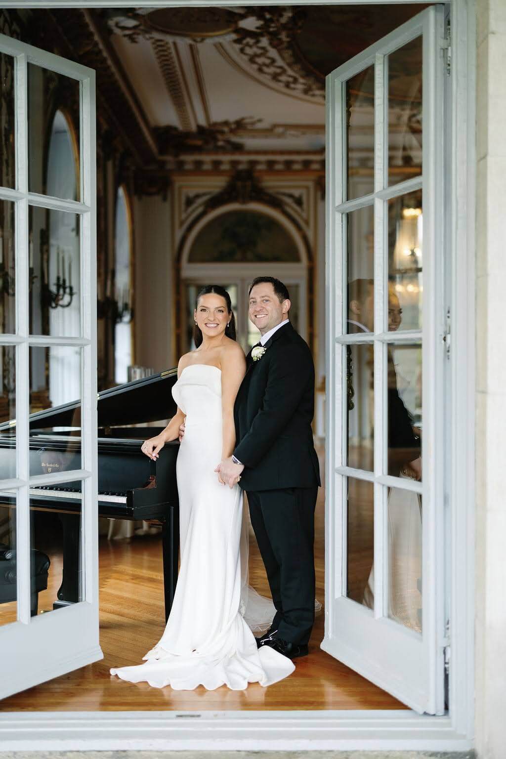 Bride and groom portrait in front of grand piano at Elkins Estate wedding venue