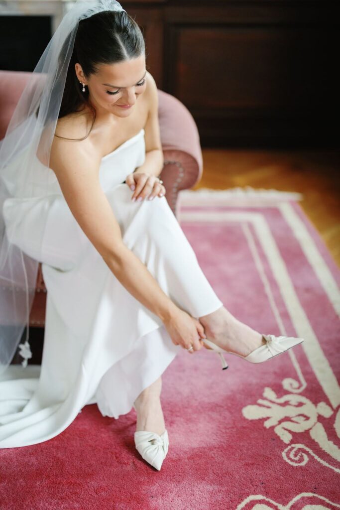 Bride puts on shoes on wedding day