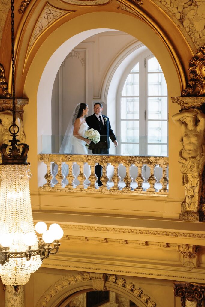 Bride and groom stroll through the hallways of Elkins Estate