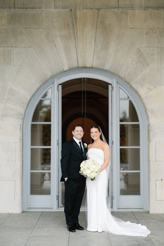 Portrait of bride and groom on the balcony of Elkins Estate