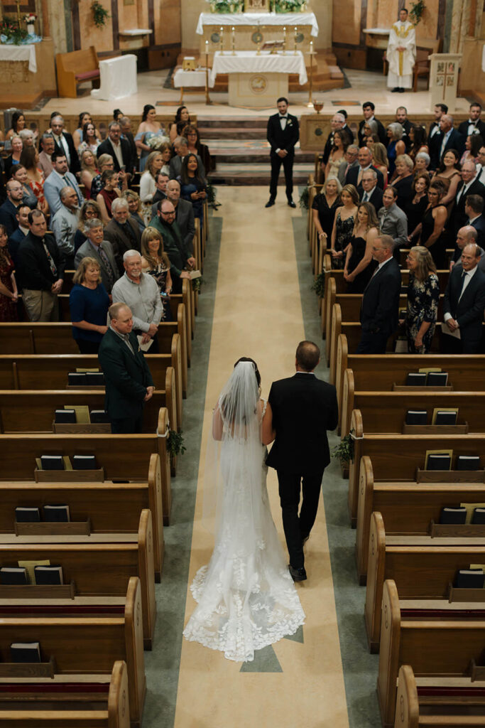 Father walking his daughter down church aisle