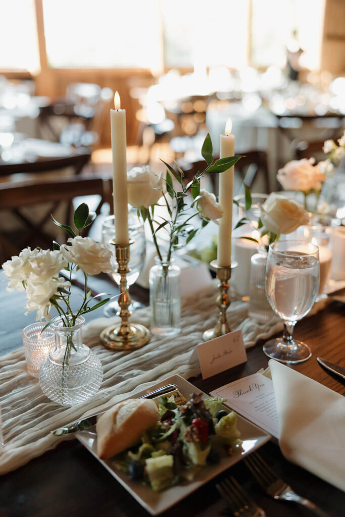 Candlelit reception table with thank you note and place card