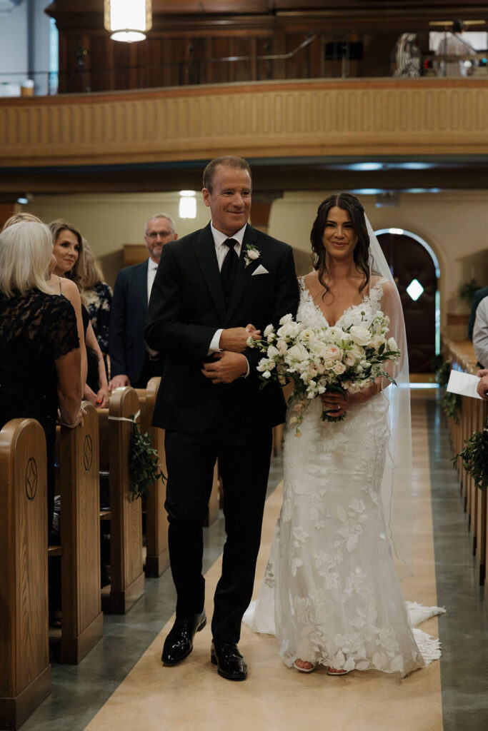 Father walking his daughter down church aisle