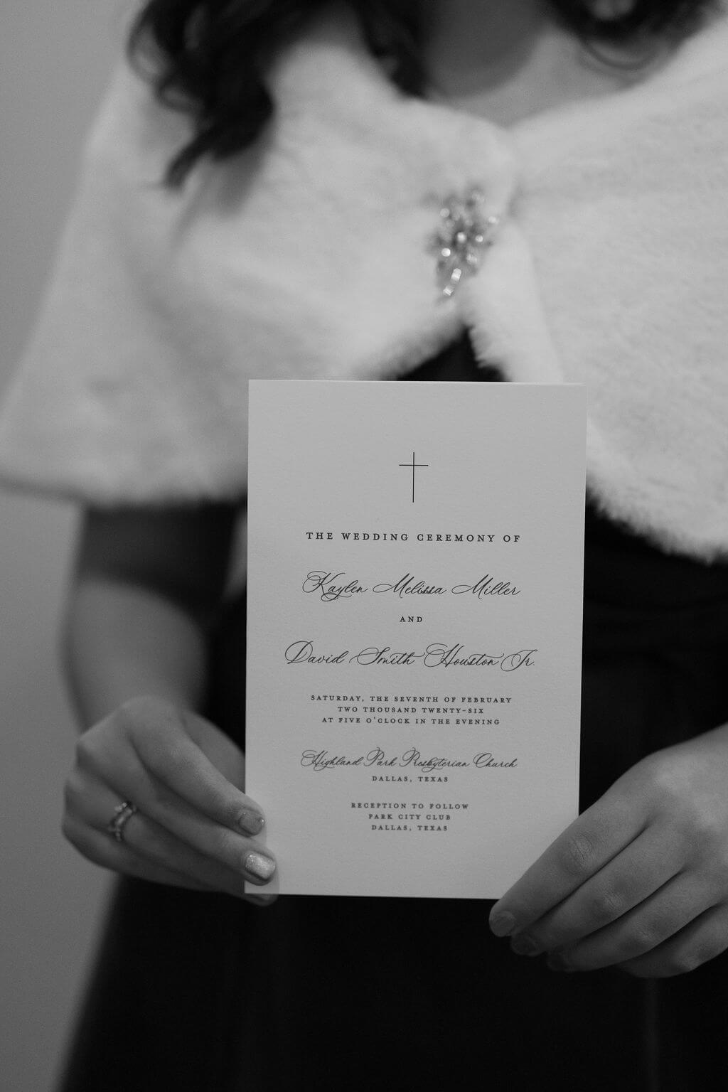 Wedding guest holding a simple and formal wedding ceremony program