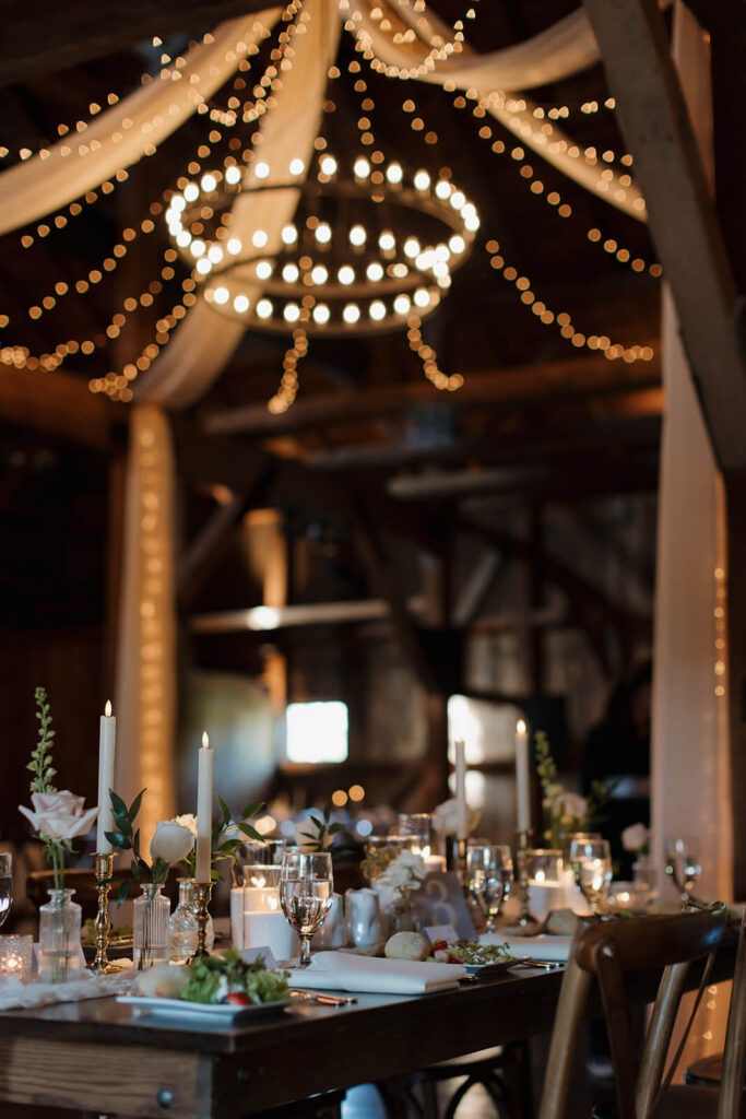 Romantic candlelit reception space in The Farm at Eagles Ridge barn