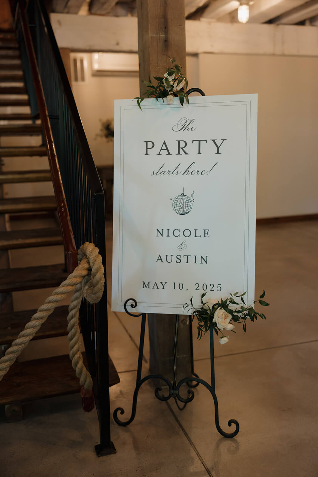 Wedding reception welcome sign with the words "The Party Starts Here" written