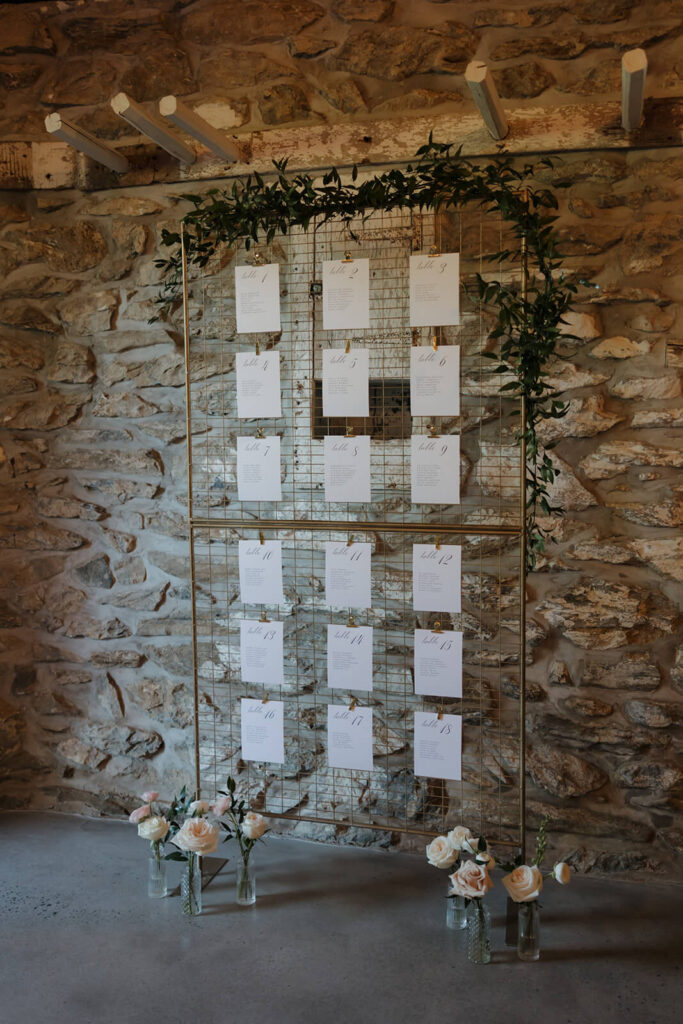 Tall gold wire frame seating chart display 
