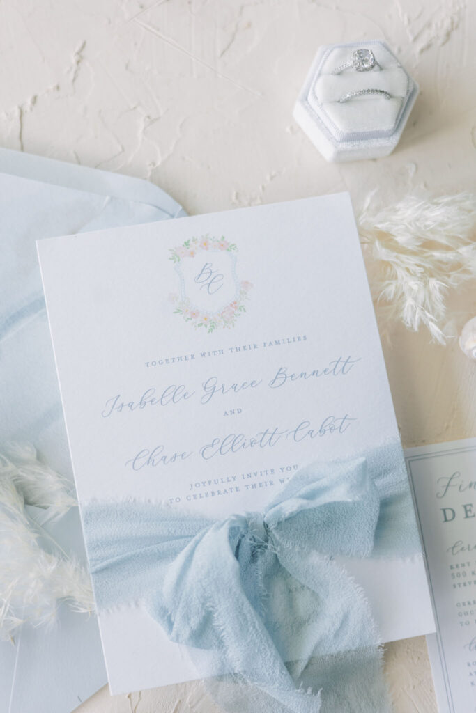 Coastal chic wedding invitation tied with a light blue silk ribbon