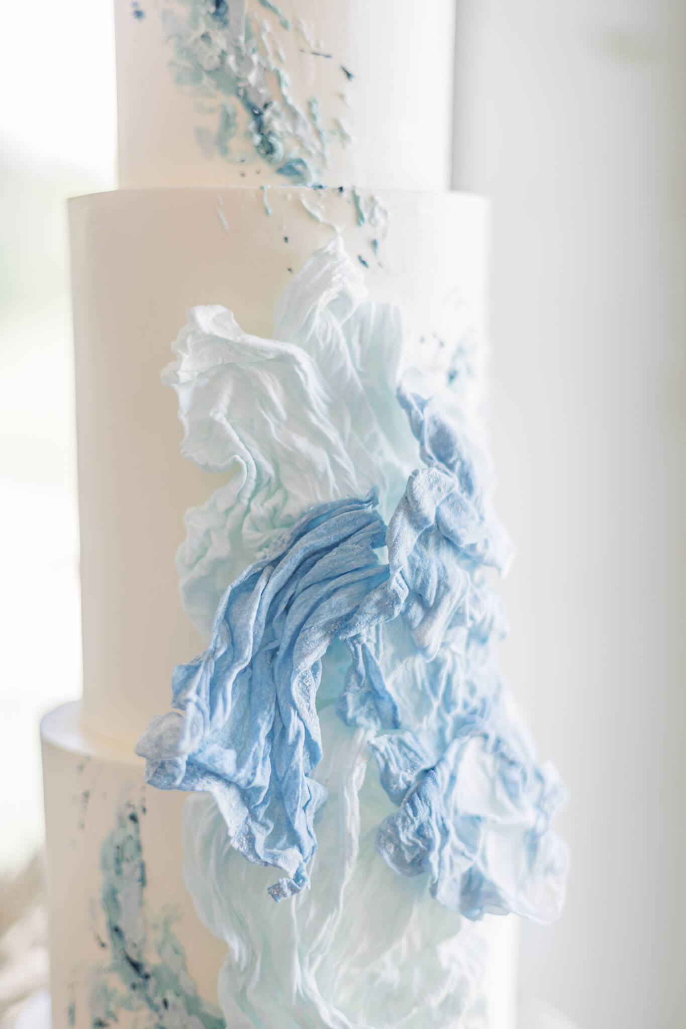 Ocean wave inspired wedding cake in whites and blues
