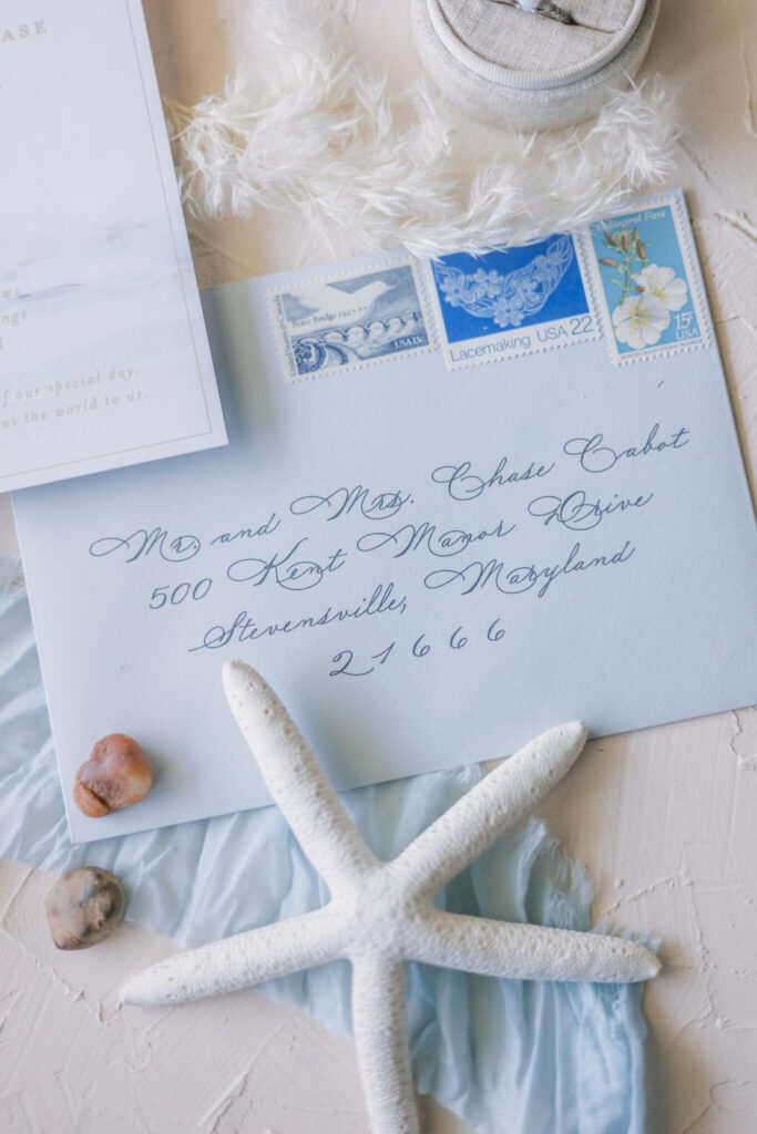 Blue wedding invitation envelope liner with calligraphed guest addressing