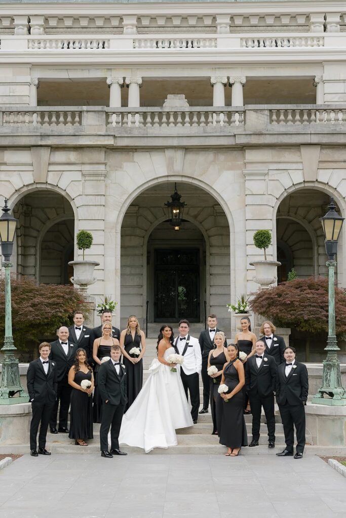 Bride and groom with wedding party, dressed in black