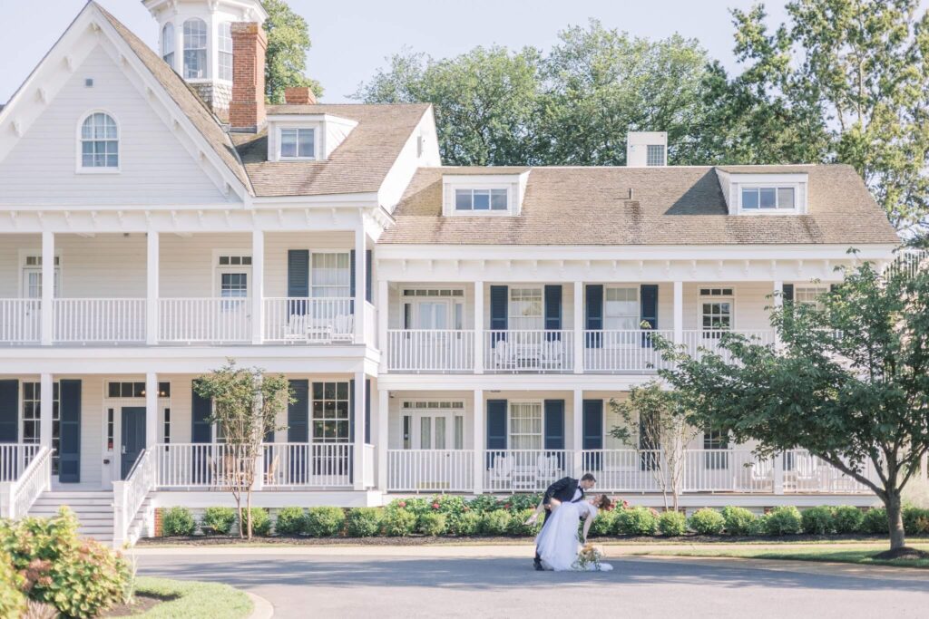 Couple embrace in front of East Coast wedding venue, Kent Island Resort