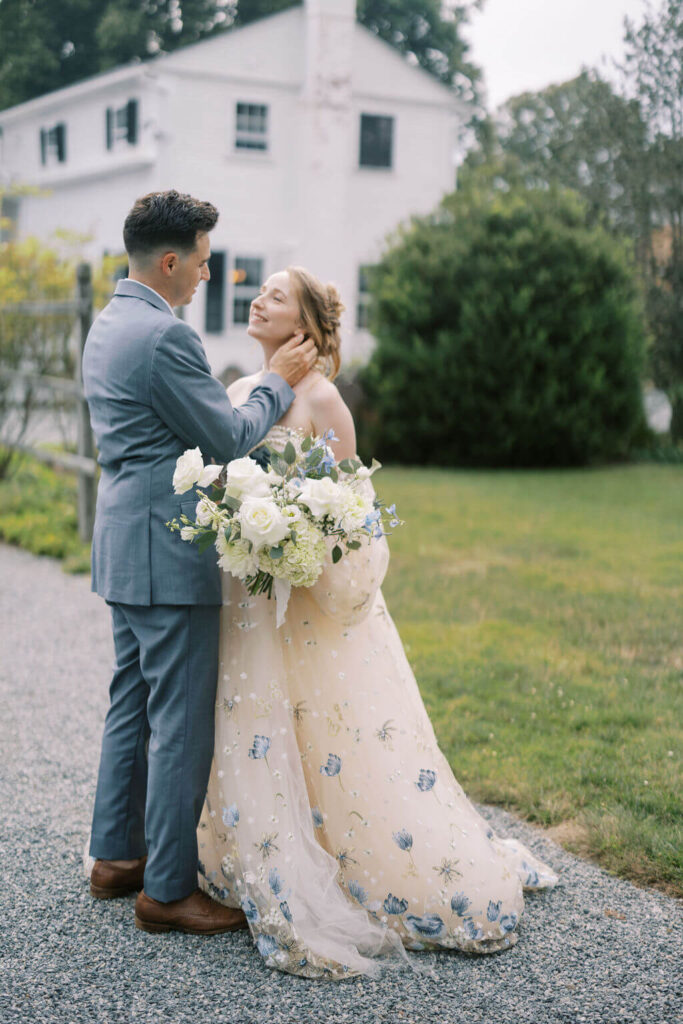Bride and groom embrace outdoors on the grounds of Linden Place