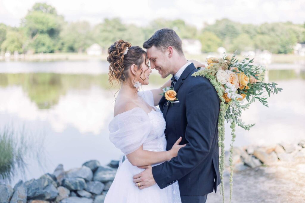 Bride and groom embrace beside the Chesapeake Bay