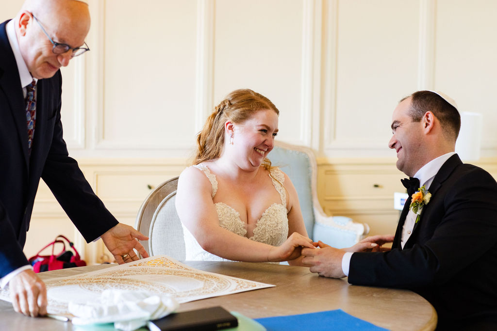 Bride and groom prepare to sign their marriage contract