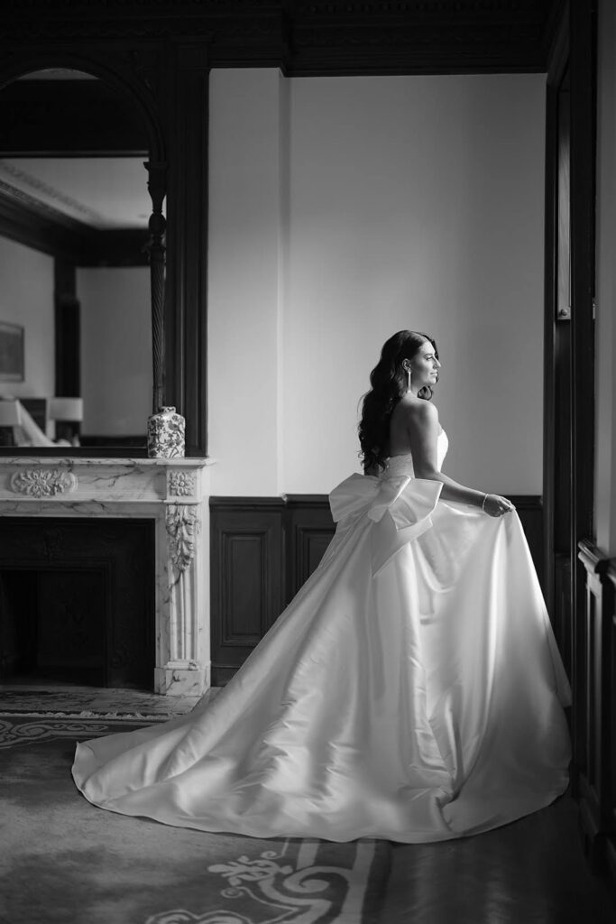 Bride looking out the window on the morning of her wedding