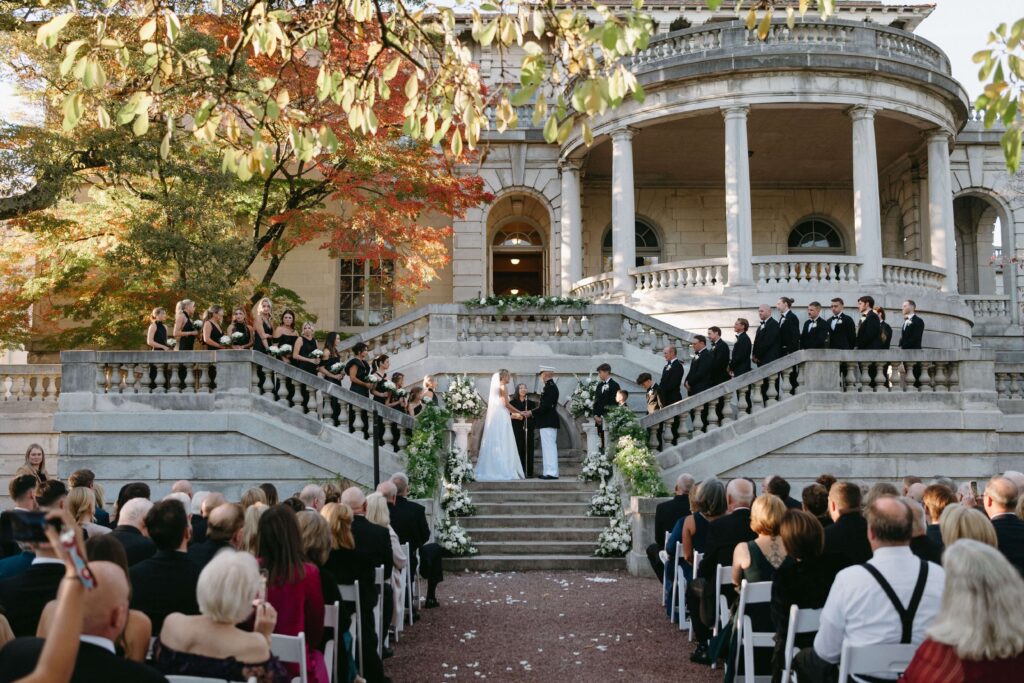 Luxury fall wedding ceremony on the stairs of Elstowe Manor at Elkins Estate