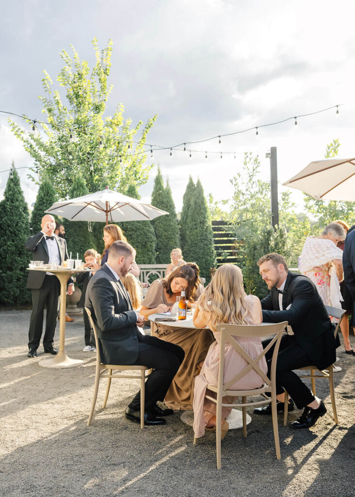 Guests enjoy cocktail hour outdoors at Terrain Gardens